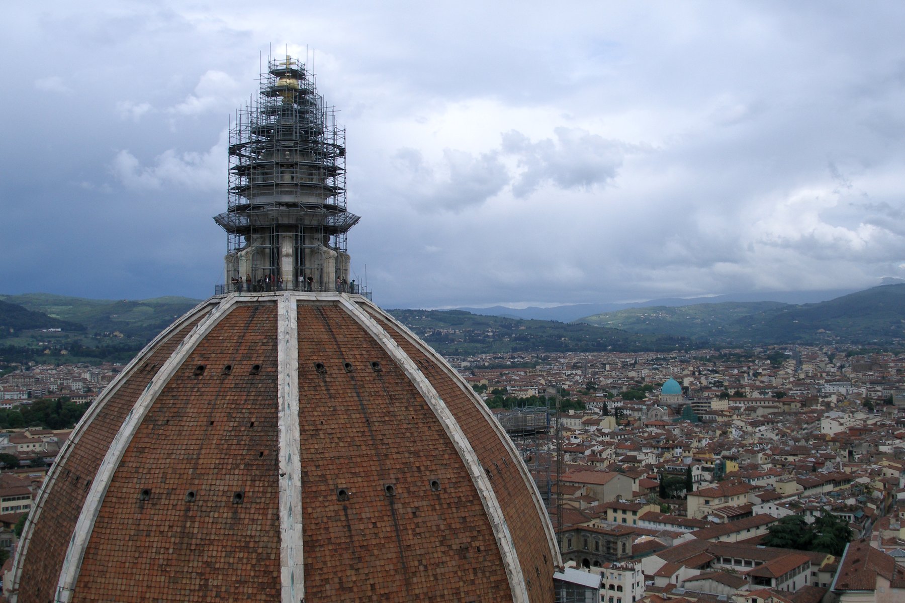 The dome of Florence Cathedral by Brunelleschi, rising in red tile and white ribs above the Florentine roofs, with the lantern at the top.