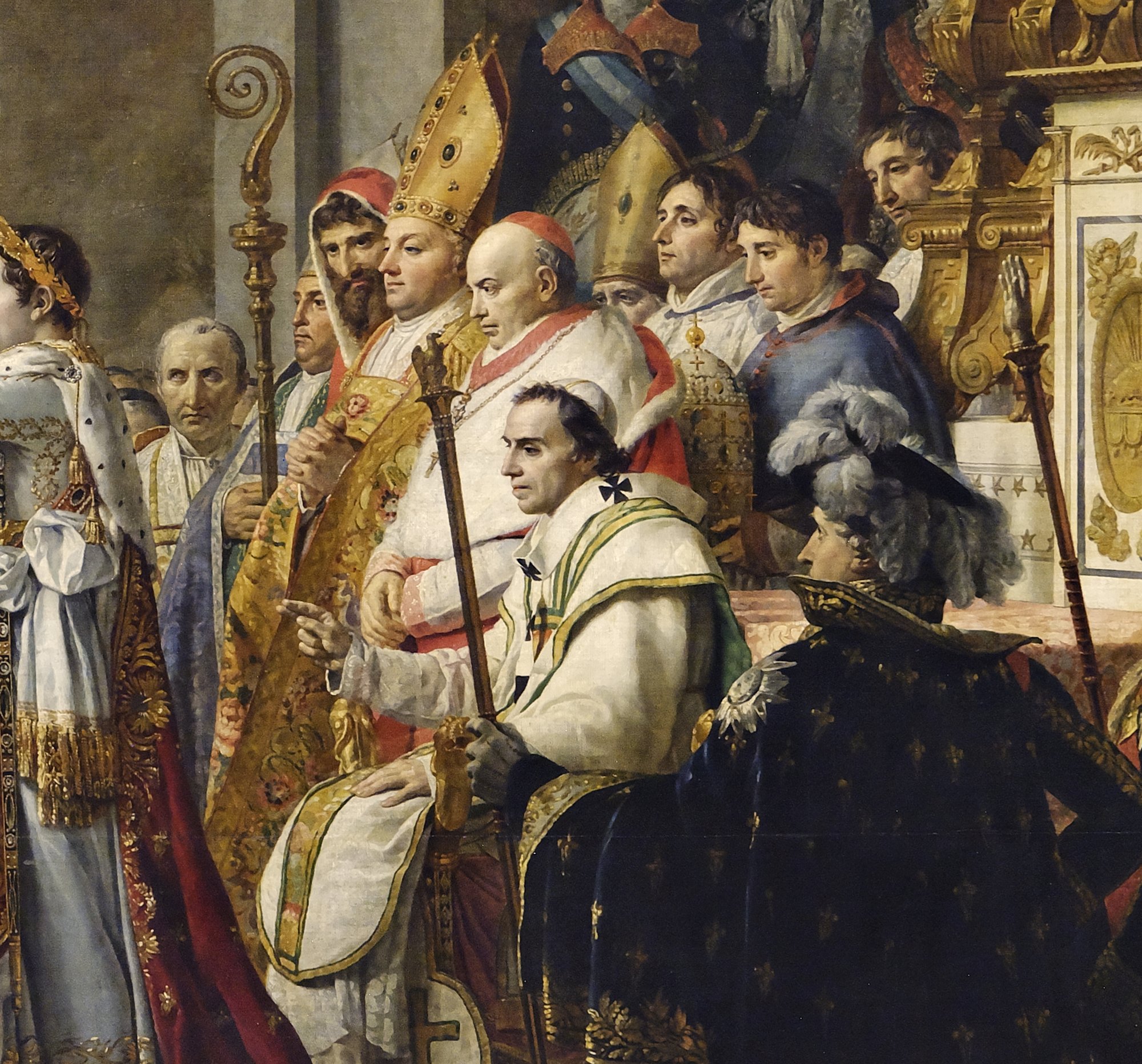 Detail of Pope Pius VII seated in white vestments with black crosses, two fingers of his right hand raised in blessing, with a cardinal in a red cap and ermine behind him and a bishop in a gold mitre with joined hands.