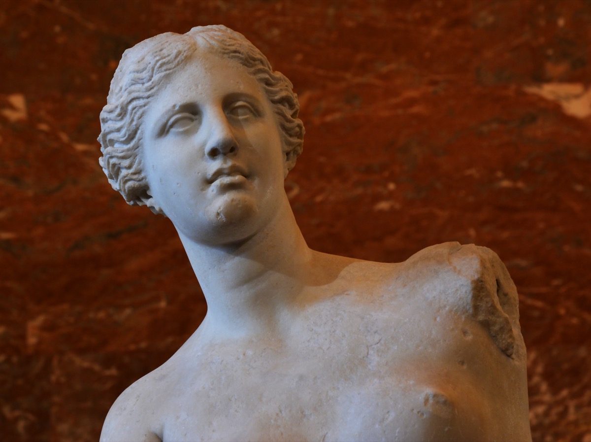 Close-up of the Venus de Milo's face and shoulders, showing the marble detail