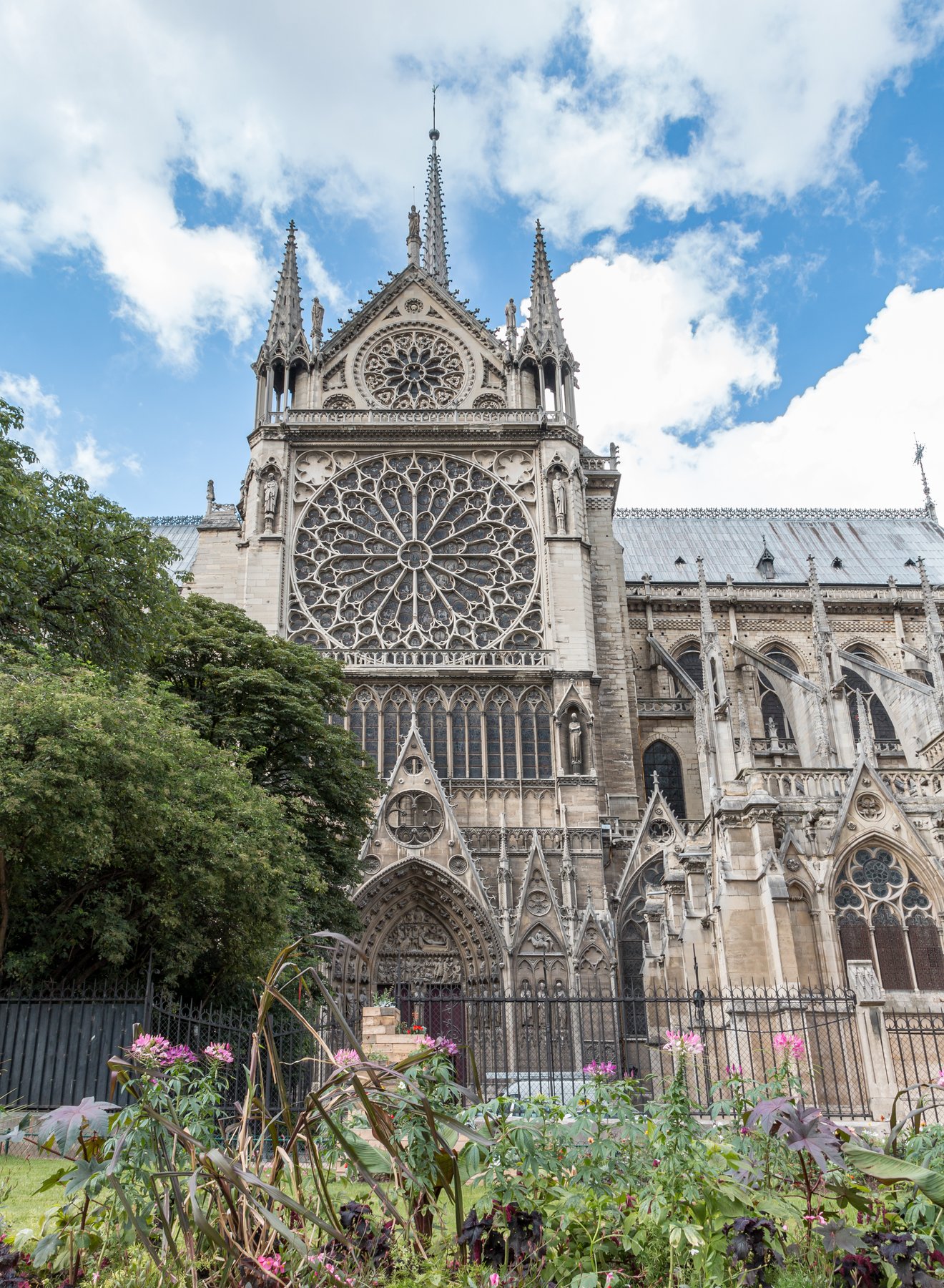 Looking down the nave of Notre-Dame de Paris from the choir toward the west rose window, with the medieval vaulted ceiling overhead and Gothic pillars running away to the entrance.