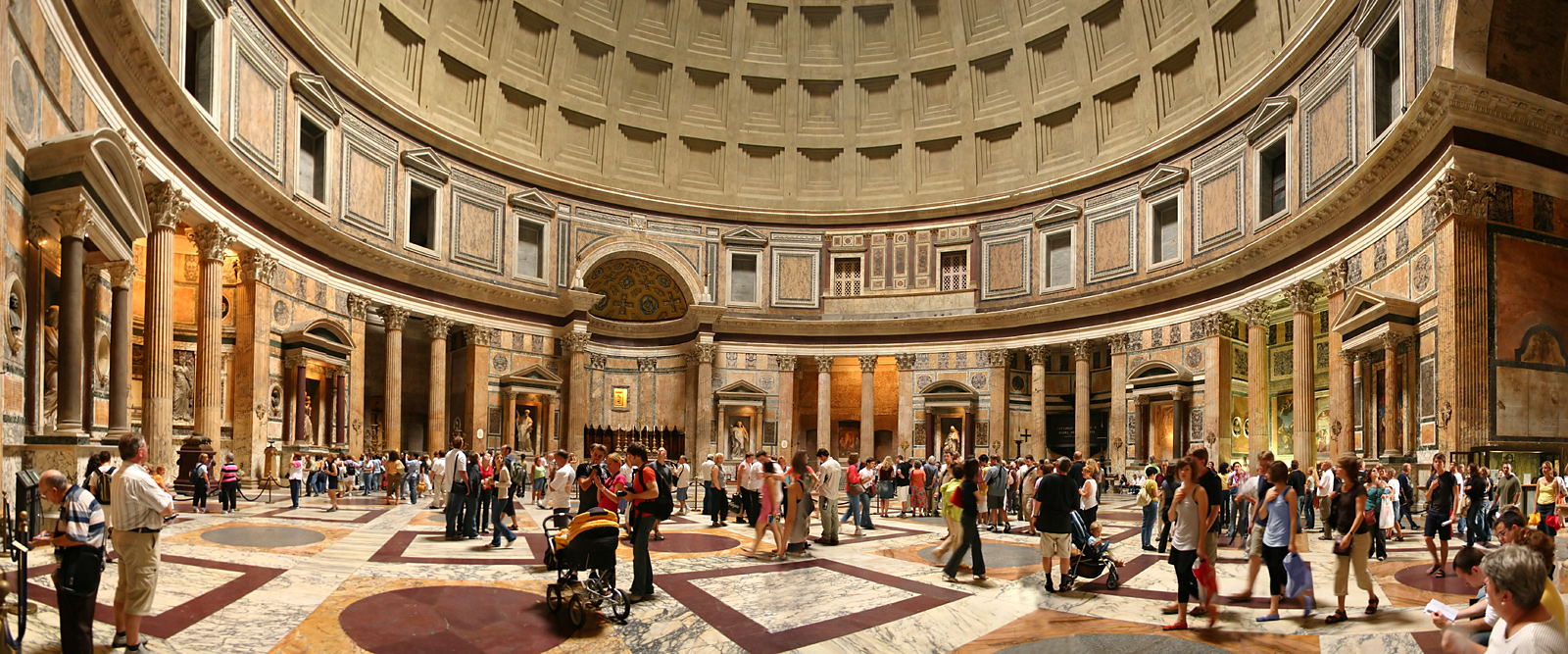 A panoramic interior view of the Pantheon showing the five concentric rings of coffers, the marble revetment of the rotunda walls, and the altar niches below.