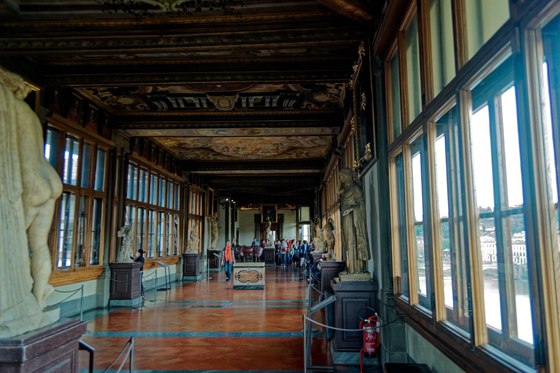 The east corridor of the Vasari Corridor section, showing the long, decorated ceiling and the kind of interior the museum's main corridors maintain — slow walks past sculptures and frescoed ceilings, between the gallery rooms.