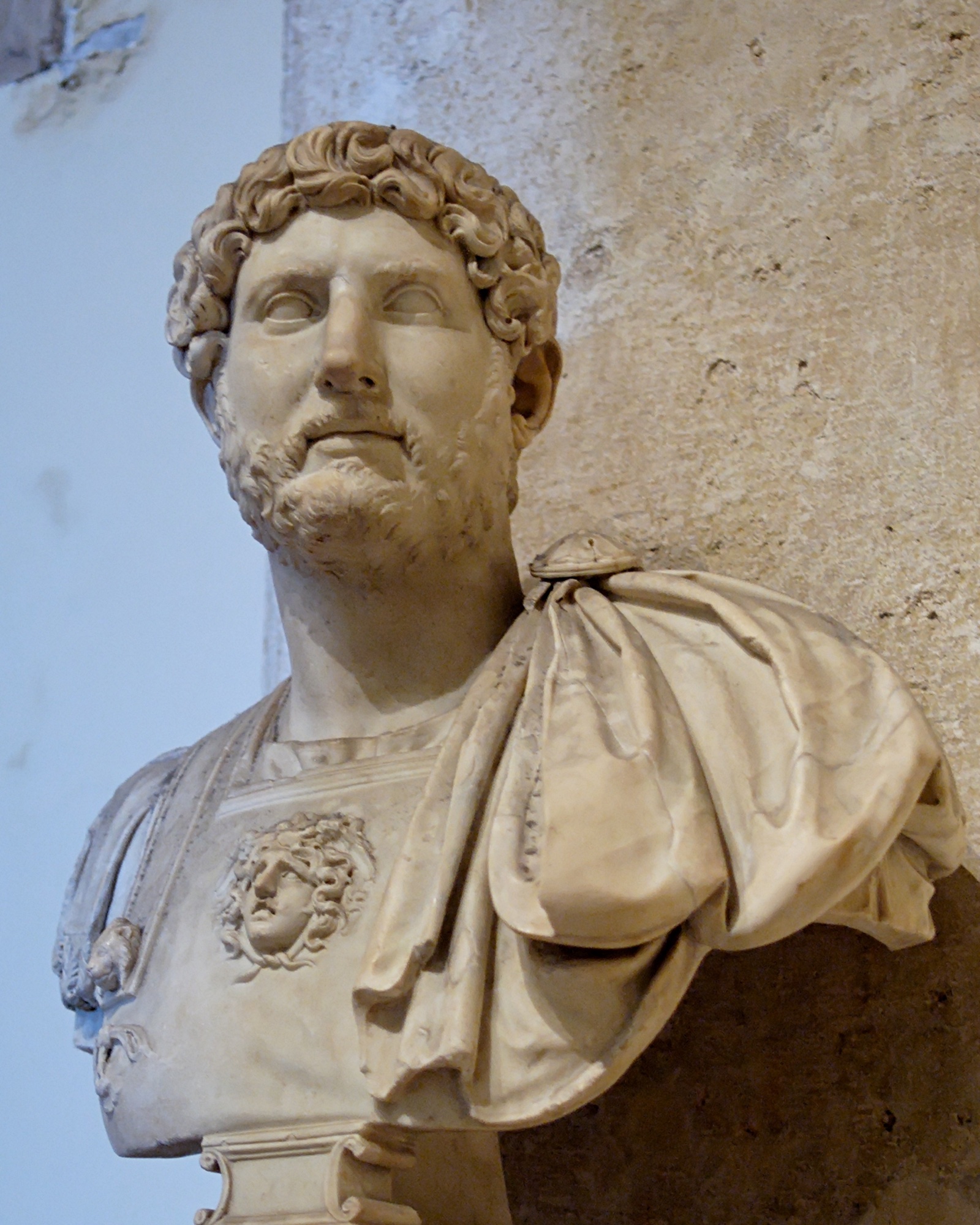 Marble bust of the Roman emperor Hadrian from the Capitoline Museums, with his characteristic short beard and wavy hair.